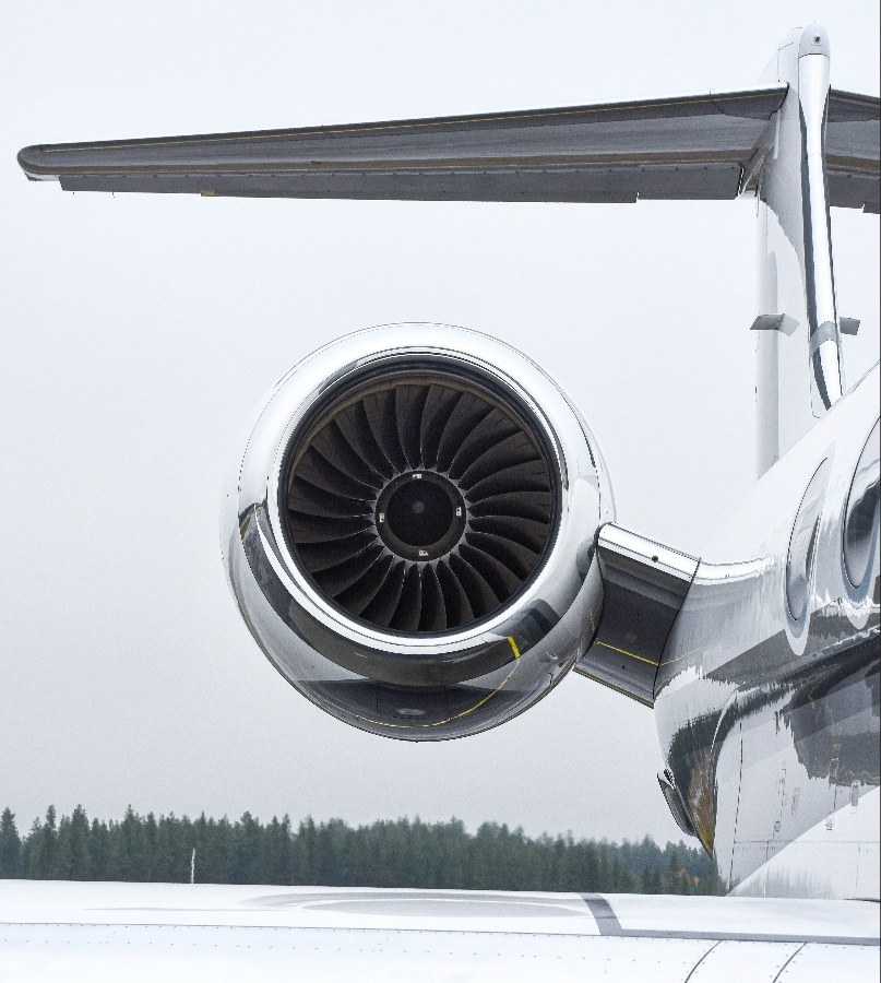 Detail of a private jet's engine and tail on the runway